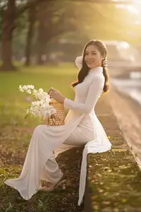 Serene Vietnamese Beauty in White Ao Dai Bathed in Golden Sunset Light - image 1