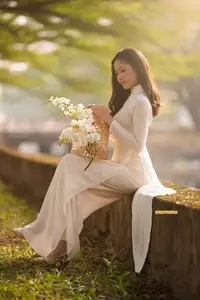 Serene Vietnamese Beauty in White Ao Dai Bathed in Golden Sunset Light - image 3