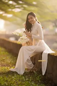 Serene Vietnamese Beauty in White Ao Dai Bathed in Golden Sunset Light - image 4