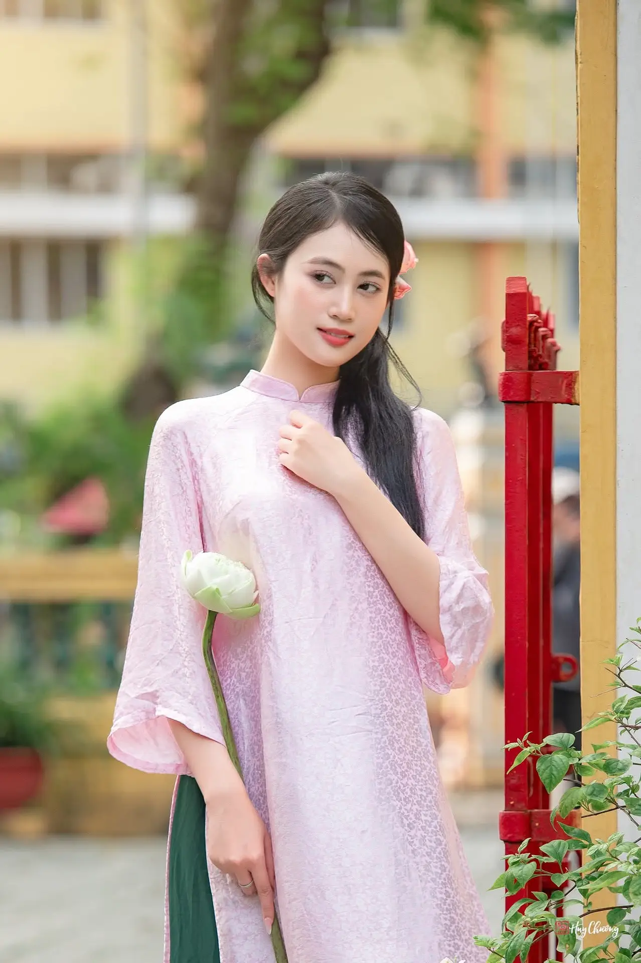 VGU No.163: The Graceful Beauty of a Vietnamese Girl in Traditional Pink Ao Dai Amidst Ancient Architecture