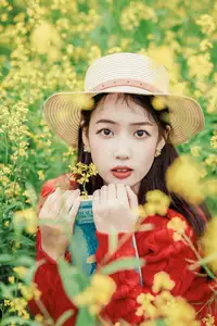 Gentle Beauty: A Girl in a Vibrant Rapeseed Flower Field, Spring Serenity - image 0