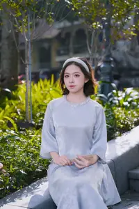 Serene Beauty: Vietnamese Young Woman by the Lake in Traditional Attire - image 1