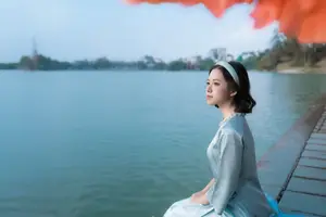 Serene Beauty: Vietnamese Young Woman by the Lake in Traditional Attire - image 5