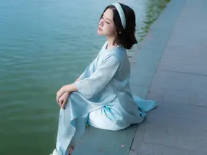 Serene Beauty: Vietnamese Young Woman by the Lake in Traditional Attire - image 0