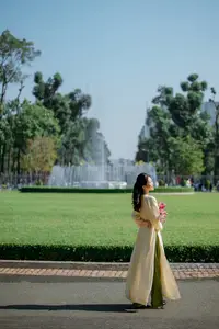 Serene Vietnamese Beauty in Ao Dai with Lilies: A Moment of Grace and Tranquility - image 9