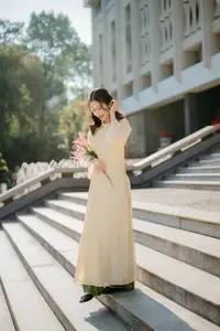 Serene Vietnamese Beauty in Ao Dai with Lilies: A Moment of Grace and Tranquility - image 1