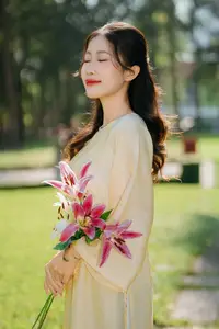 Serene Vietnamese Beauty in Ao Dai with Lilies: A Moment of Grace and Tranquility - image 2