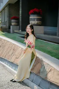 Serene Vietnamese Beauty in Ao Dai with Lilies: A Moment of Grace and Tranquility - image 0
