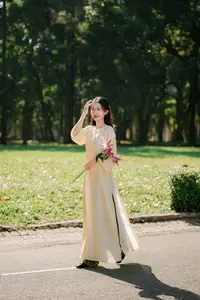Serene Vietnamese Beauty in Ao Dai with Lilies: A Moment of Grace and Tranquility - image 11