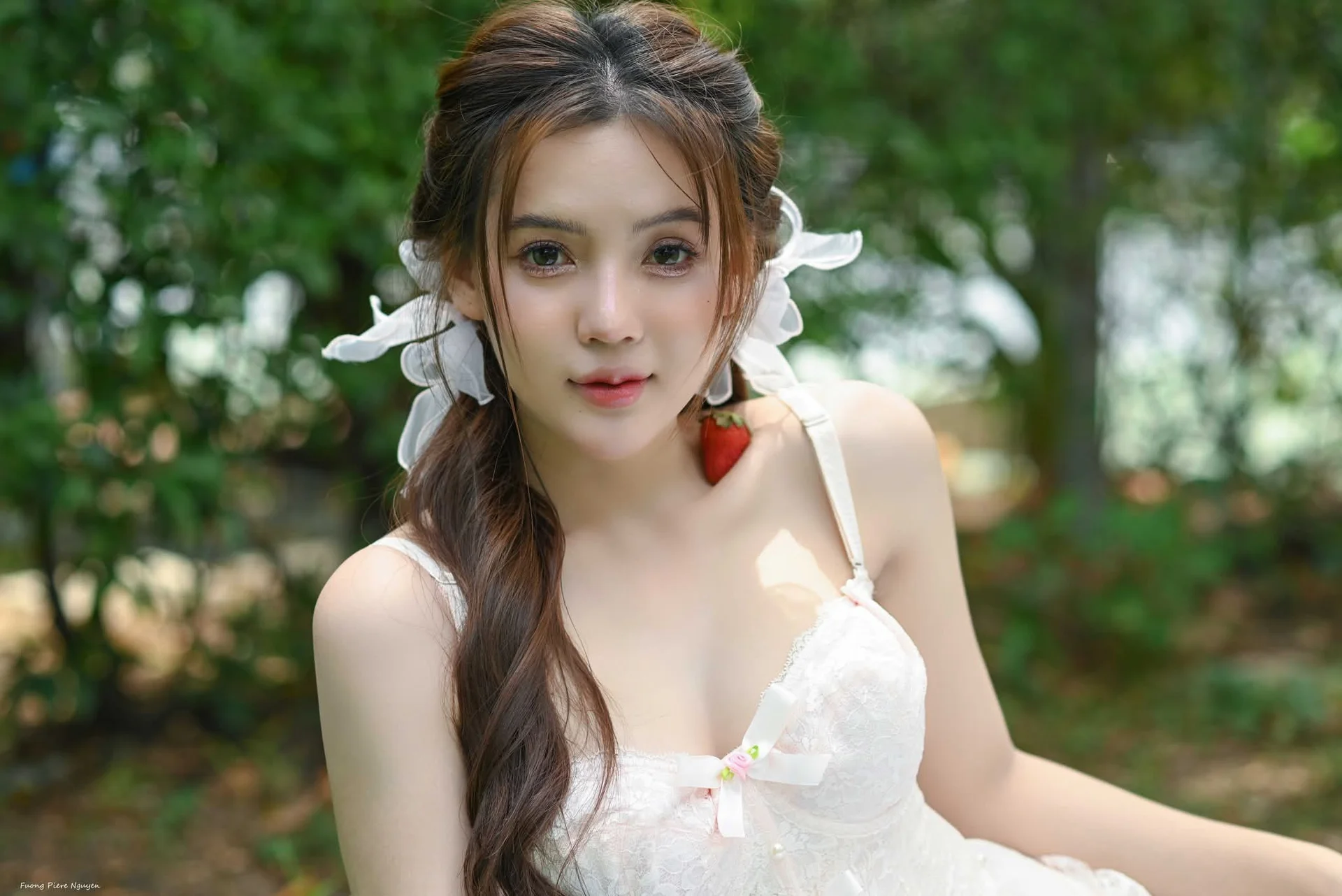 Ethereal Beauty: Young Woman in White Amidst Lush Green Nature