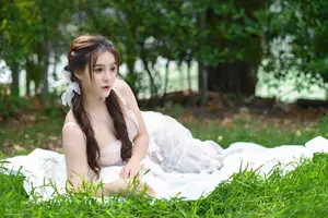 Ethereal Beauty: Young Woman in White Amidst Lush Green Nature - image 5