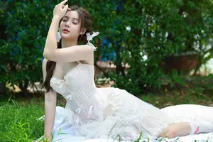 Ethereal Beauty: Young Woman in White Amidst Lush Green Nature - image 3