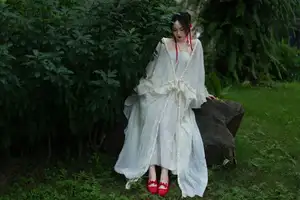 Elegant Woman in White Dress Amidst Lush Green Nature - image 10