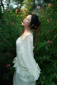 Elegant Woman in White Dress Amidst Lush Green Nature - image 6