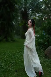 Elegant Woman in White Dress Amidst Lush Green Nature - image 12