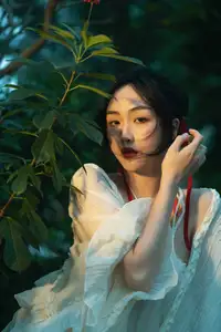 Elegant Woman in White Dress Amidst Lush Green Nature - image 2