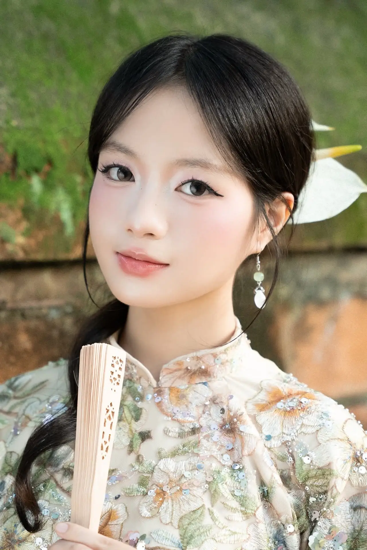 East Asian Traditional Beauty: Gentle Young Woman in Ao Dai with Elegant Wooden Fan