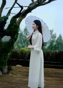 Graceful Vietnamese Woman in White Ao Dai with Lotus Flower in Serene Garden - image 2