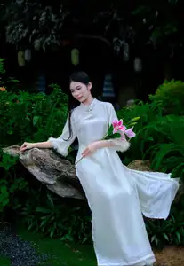 Graceful Vietnamese Woman in White Ao Dai with Lotus Flower in Serene Garden - image 5