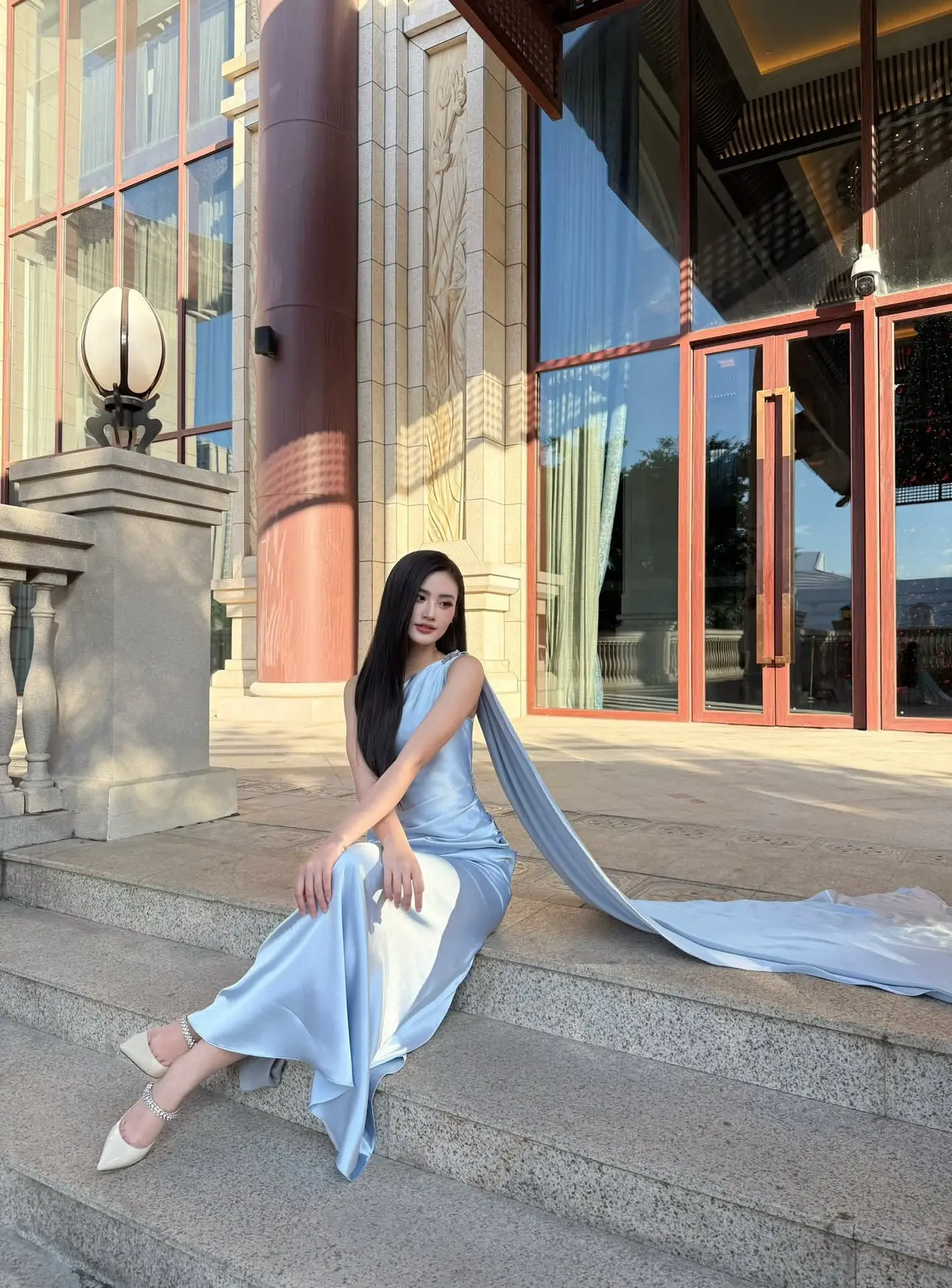 Miss Ý Nhi Radiates Elegance: A Vision in Her Sophisticated Evening Gown on Grand Ancient Stairs