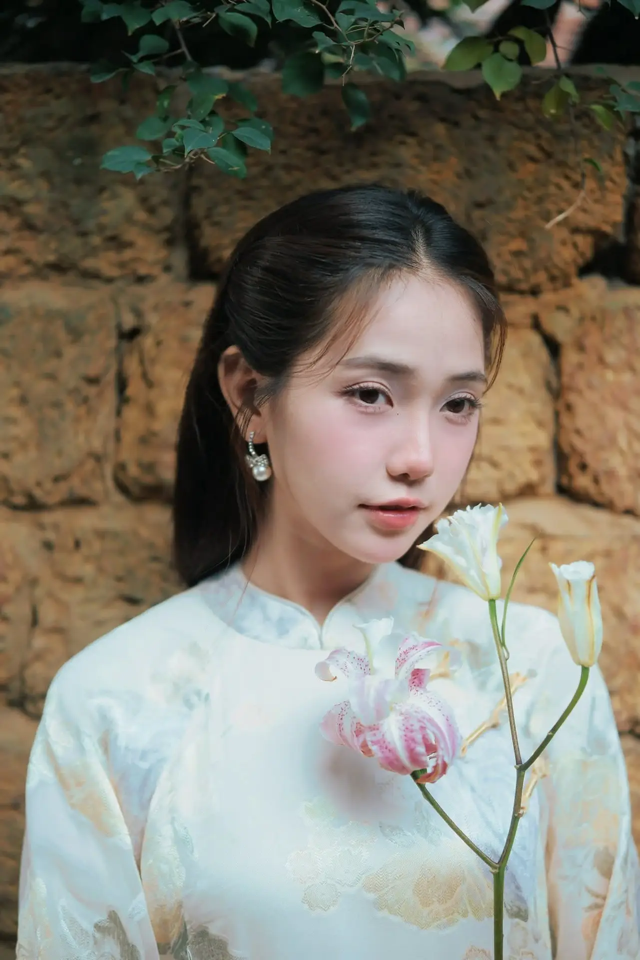 Captivating Asian Beauty: Elegant Woman Embracing Delicate Flowers