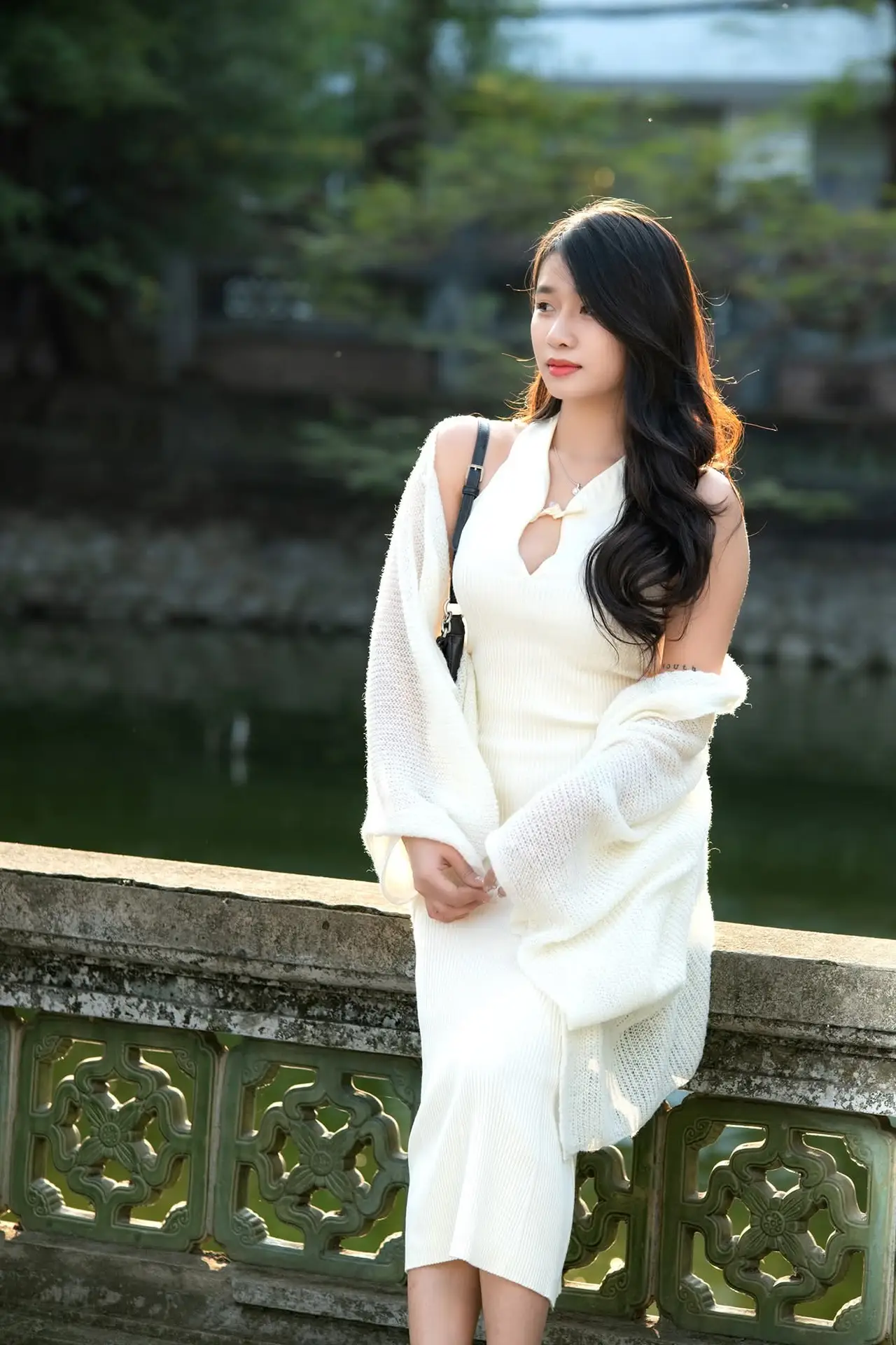 Elegant Beauty in Pristine White Dress Under Golden Afternoon Sun 1000027006