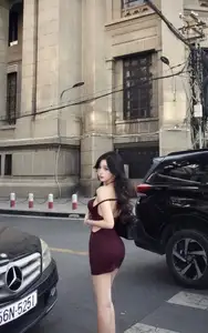 Charming Woman in Elegant Burgundy Mini Dress Defines Urban Street Style - image 0
