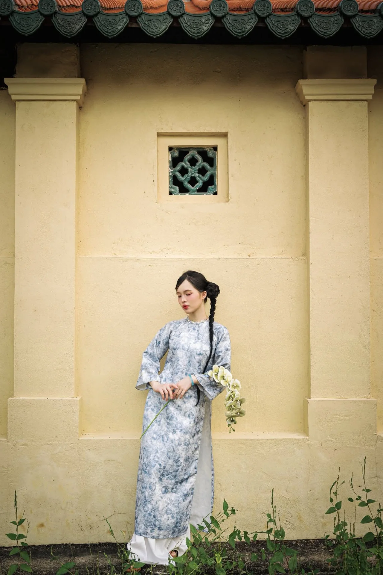 Timeless Grace in Blue Floral Ao Dai and Ancient Architecture