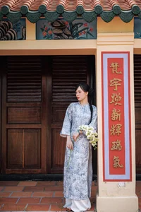 Timeless Grace in Blue Floral Ao Dai and Ancient Architecture - image 3