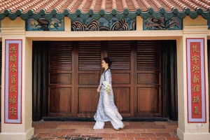 Timeless Grace in Blue Floral Ao Dai and Ancient Architecture - image 2