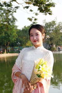 VGU No.148: Radiant Smile in Traditional Ao Dai: Elegant Vietnamese Beauty by the Lake. - image 1