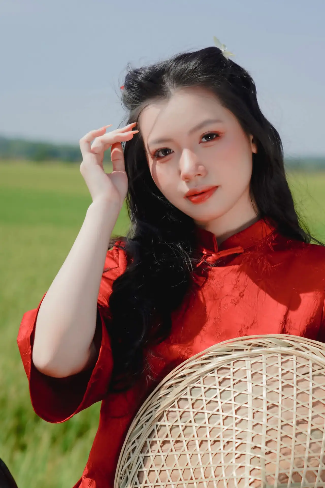 Discover the Serene Beauty: Vietnamese Girl in Red Ao Dai Amidst Green Rice Fields