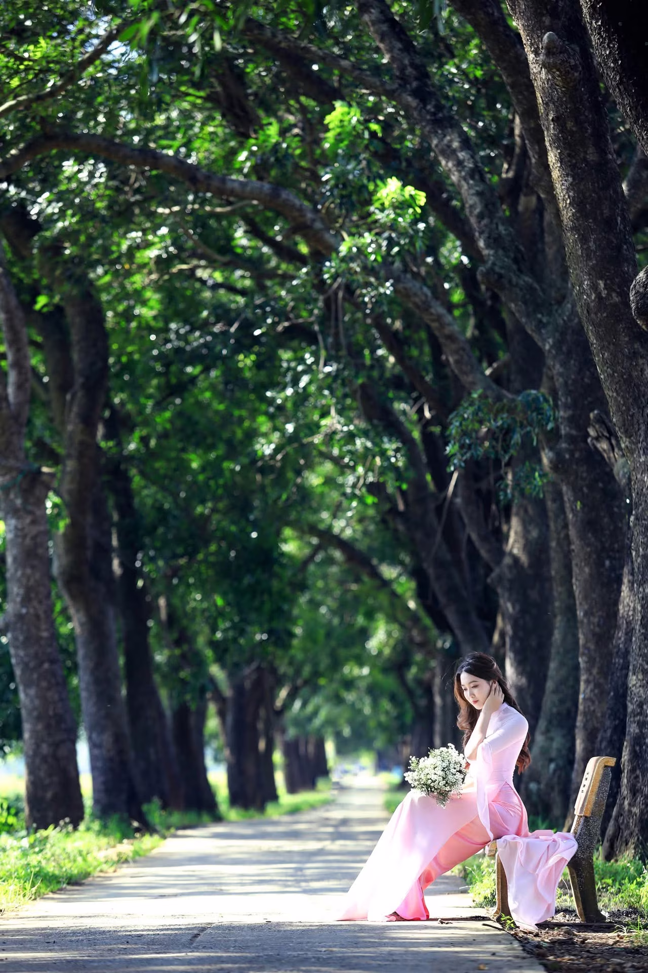 VGU No.150: Graceful Vietnamese Beauty in Pink Ao Dai on a Serene Path