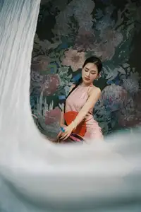 Discover Vietnamese Grace: An Elegant Girl in Ao Yem with a Red Fan. - image 3