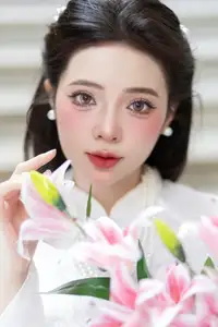 Serene Vietnamese Beauty: A Gentle Muse in White with Pink Lilies - image 1