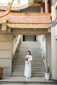 Serene Vietnamese Beauty: A Gentle Muse in White with Pink Lilies - image 9