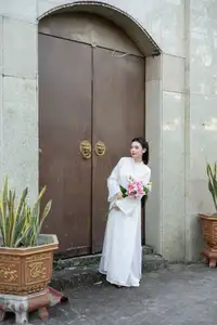 Serene Vietnamese Beauty: A Gentle Muse in White with Pink Lilies - image 7
