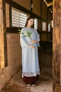 Serene Beauty: Graceful Young Woman in Traditional Attire with White Lilies - image 11