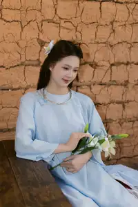 Serene Beauty: Graceful Young Woman in Traditional Attire with White Lilies - image 0