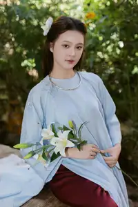 Serene Beauty: Graceful Young Woman in Traditional Attire with White Lilies - image 3