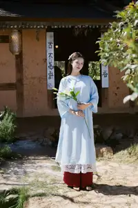 Serene Beauty: Graceful Young Woman in Traditional Attire with White Lilies - image 7
