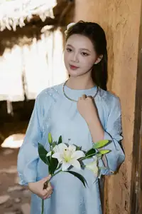 Serene Beauty: Graceful Young Woman in Traditional Attire with White Lilies - image 4