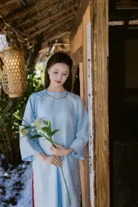 Serene Beauty: Graceful Young Woman in Traditional Attire with White Lilies - image 1
