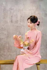 Elegant Asian Charm: Serene Young Woman in Traditional Pink Attire with Delicate Fresh Flowers - image 8