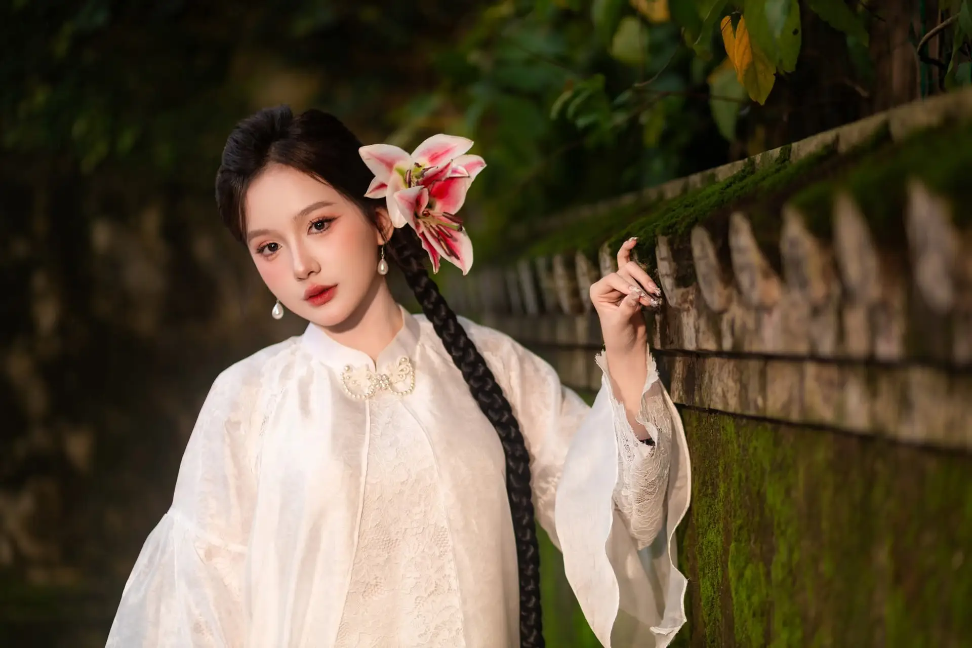 Captivating Asian Beauty: Discover the Ethereal Charm of a Maiden in White with a Blossom in Her Hair.