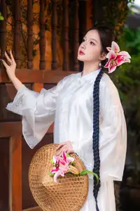 Captivating Asian Beauty: Discover the Ethereal Charm of a Maiden in White with a Blossom in Her Hair. - image 1