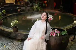 Captivating Asian Beauty: Discover the Ethereal Charm of a Maiden in White with a Blossom in Her Hair. - image 2