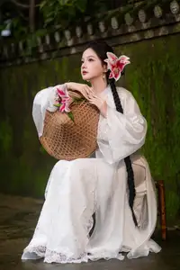 Captivating Asian Beauty: Discover the Ethereal Charm of a Maiden in White with a Blossom in Her Hair. - image 0