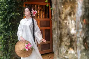 Captivating Asian Beauty: Discover the Ethereal Charm of a Maiden in White with a Blossom in Her Hair. - image 3