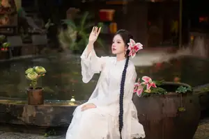 Captivating Asian Beauty: Discover the Ethereal Charm of a Maiden in White with a Blossom in Her Hair. - image 4